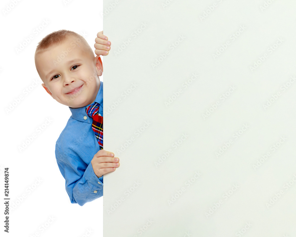 boy peeks out from behind the banner boy peeks out from behind the banner