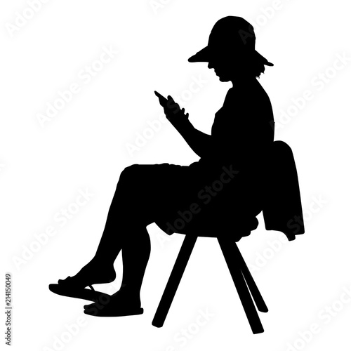 Woman silhouette sitting on a chair with mobile phone