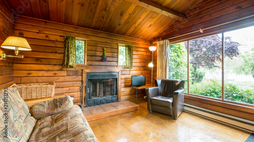 Cozy interior of a living room in a rustic log cabin.