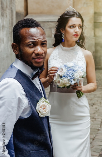 Wedding day. Stylish african groom and his pretty bride.
