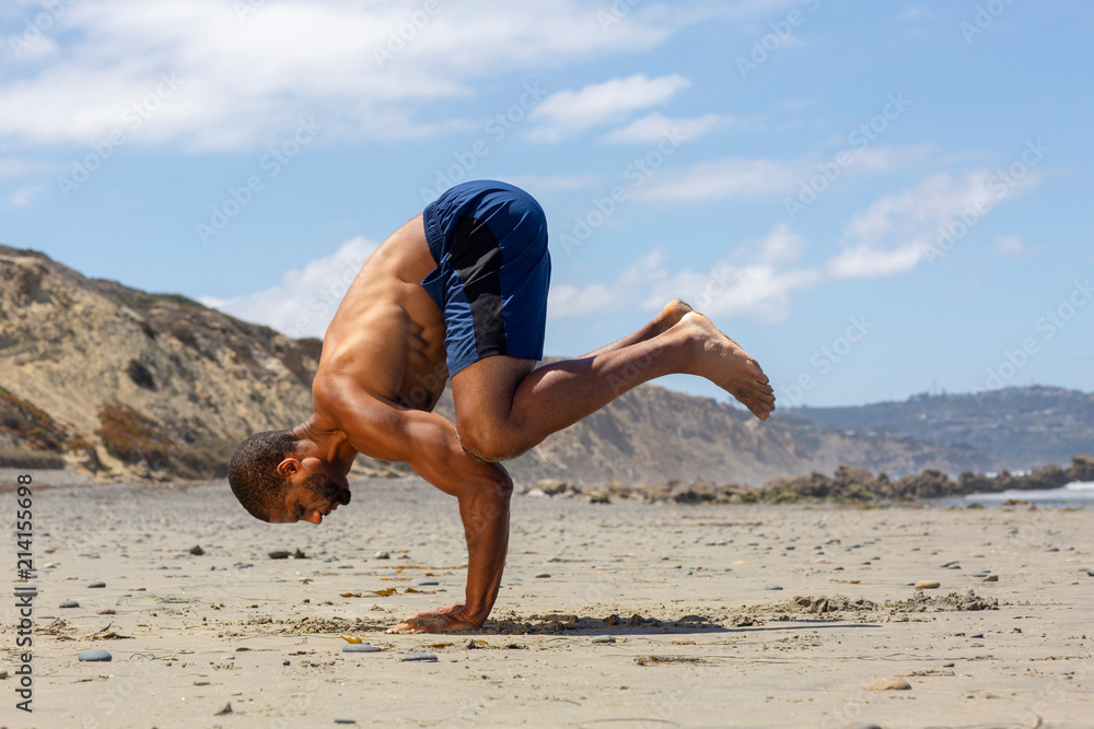 Yogi man in cobra pose on beach - a Royalty Free Stock Photo from Photocase