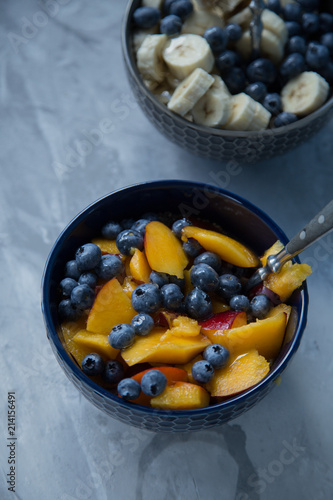 Breakfast bowl with oat flakes and fruits and berries like blueberries , nectarines and bananas
