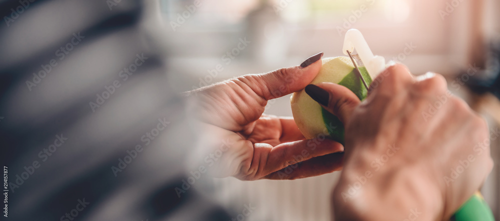 Woman peeling apples