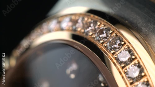 Luxury expensive fashion gold watches with sapphires and diamons.Arrows ticking. Close up 4k macro shot. photo