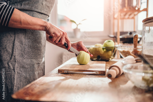 Woman cutting apples in the kitchen