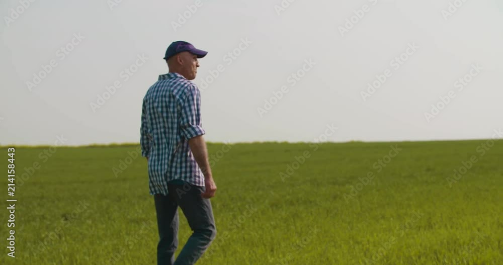 Tired Farmer Stretching While Walking In Farm Tired Farmer Stretching While Walking In Farm