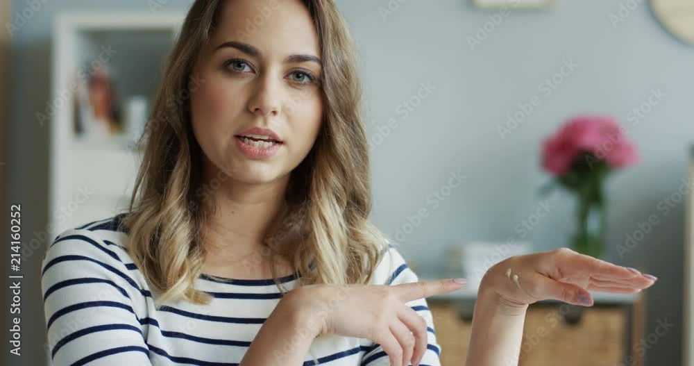 Close up of the young beautiful beauty blogger talking on how to choose and use foundation for a face in her video blog. Indoor. Close up of the young beautiful beauty blogger talking on how to choose and use foundation for a face in her video blog. Indoor.
