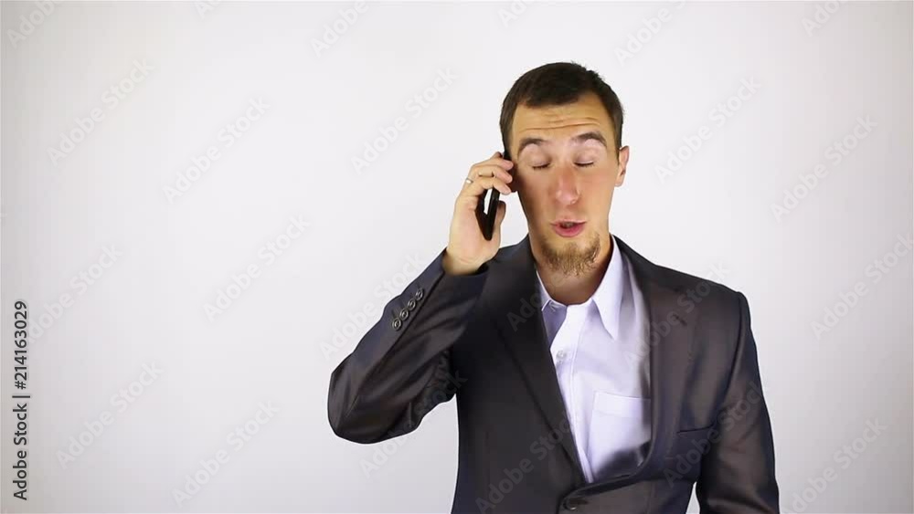 young bearded man talking on the phone. bad news.