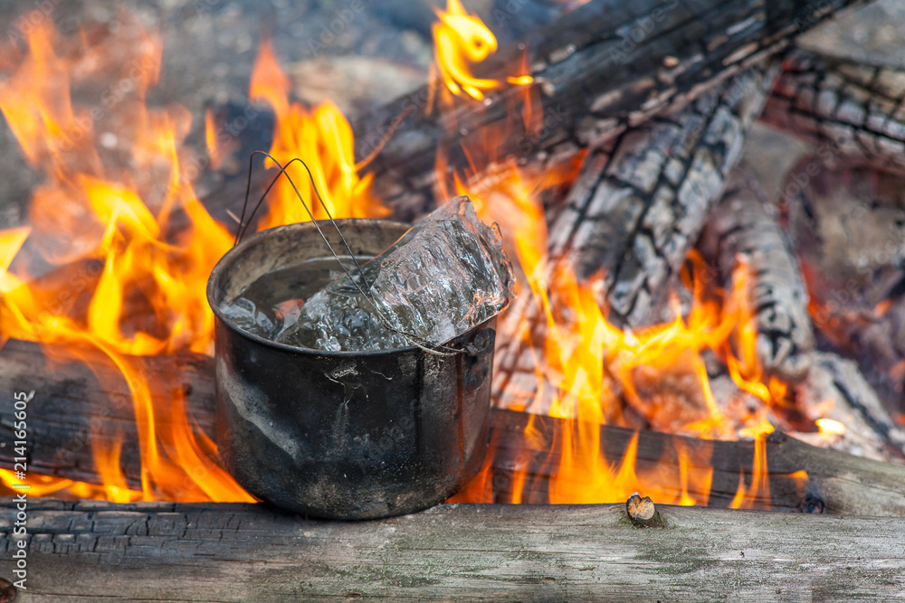 Cooking in the nature. Cauldron with ice on fire in forest. Kitchen in travel. Cooking in the nature. Cauldron with ice on fire in forest. Kitchen in travel.