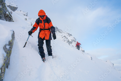 Teamwork in alpinism. Mountaineering. Traverse of mountain. 