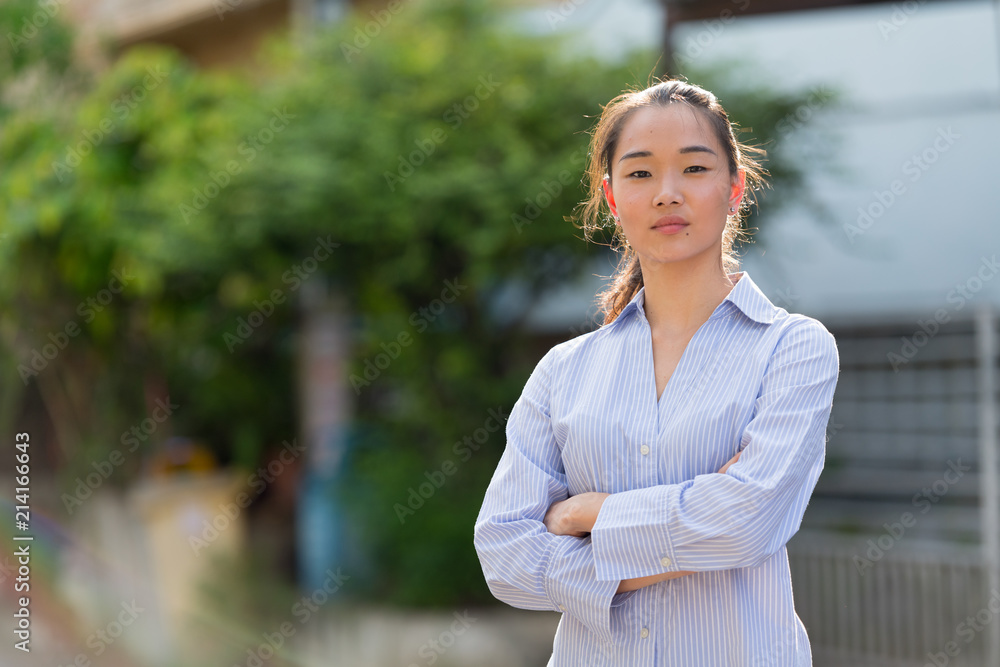 Young beautiful Asian businesswoman outdoors Young beautiful Asian businesswoman outdoors