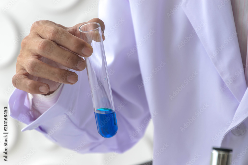 Scientists holding a beaker. Scientists holding a beaker.