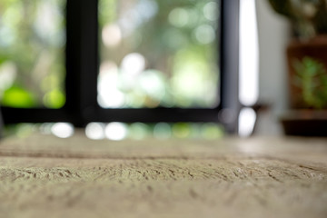 Closeup image of vintage wooden table foreground with blur background in cafe
