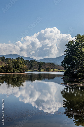 Fototapeta Naklejka Na Ścianę i Meble -  smokey mountain lake with clouds and reflection