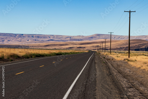 Palouse country highway going in to the distance in to rolling desert hills