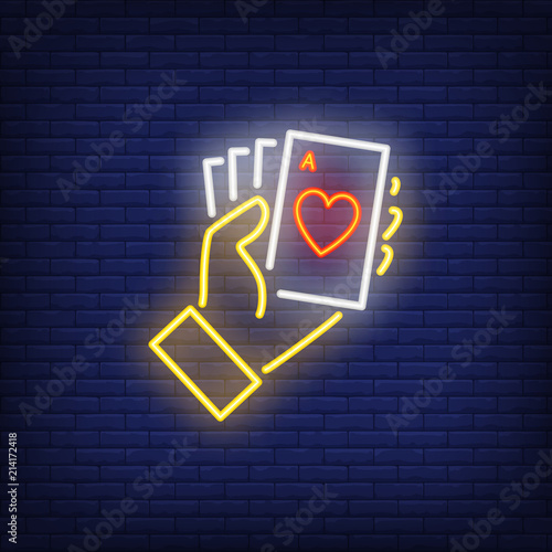 Hand holding ace cards neon sign. Heart, poker, gambler. Night bright advertisement. Vector illustration in neon style for gambling, casino and poker club