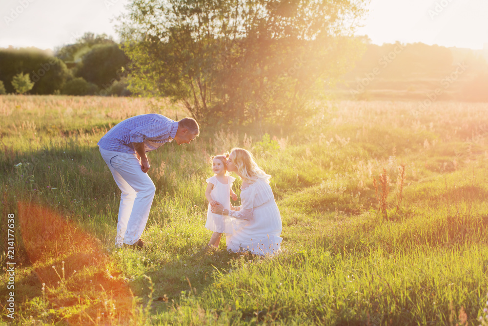 happy family in summer park at sunset