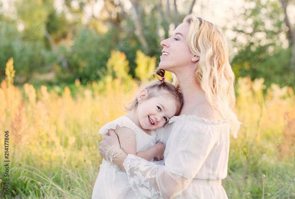 mother and daughter on summer meadow mother and daughter on summer meadow