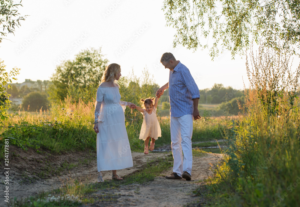 happy family in summer park at sunset happy family in summer park at sunset