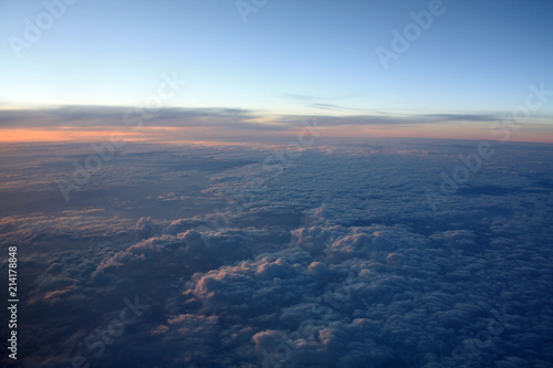 Sunset in the clouds. Sunrise sky. High in the sky. View from plane window. Sunset. 