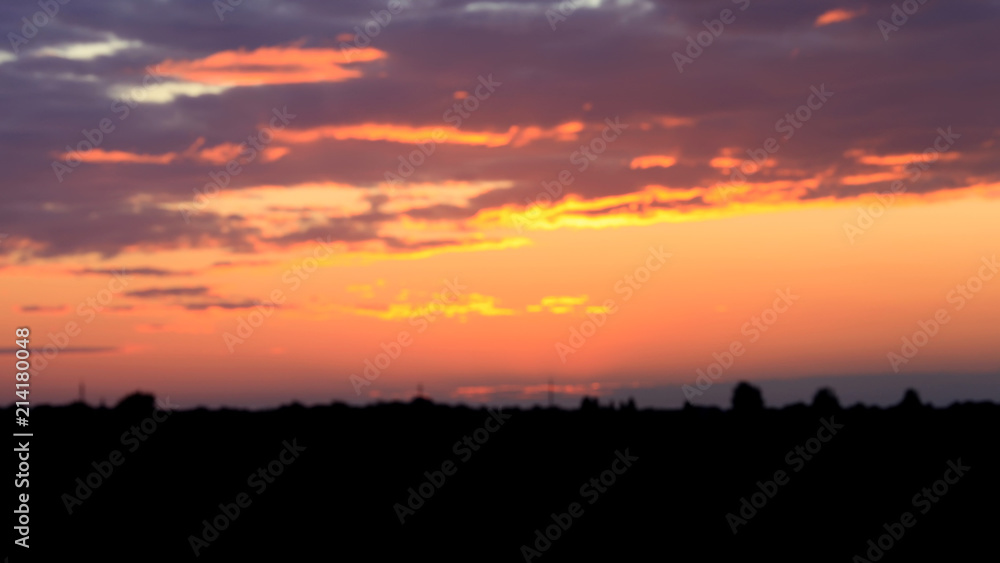 Beautiful sunset. Blurred image of the dramatic sunset in the steppes in the Astrakhan region. Russia. Dramatic clouds as a natural background.