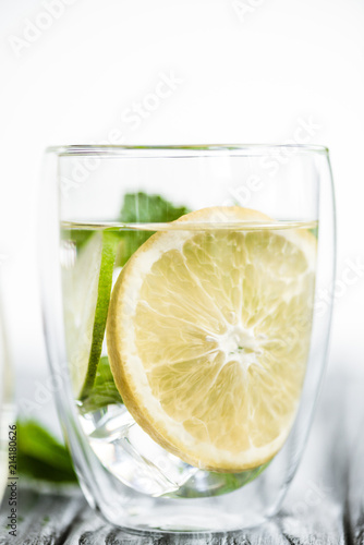 close-up view of fresh cold mojito cocktail in glass on wooden table