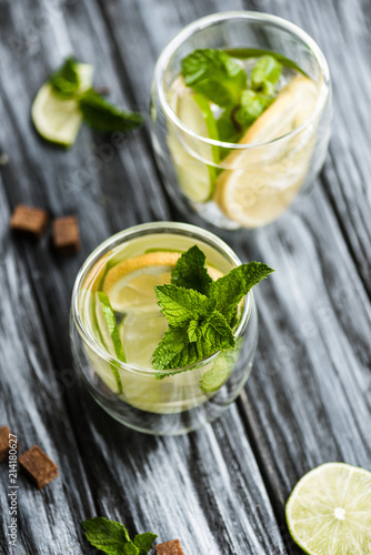 high angle view of fresh cold mojito cocktail in glasses on wooden table