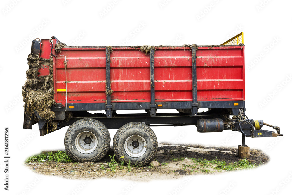 Agricultural machinery on a dairy farm. Trailer-distributor of fertilizers from cow manure and straw after working in the field. Isolated side view.