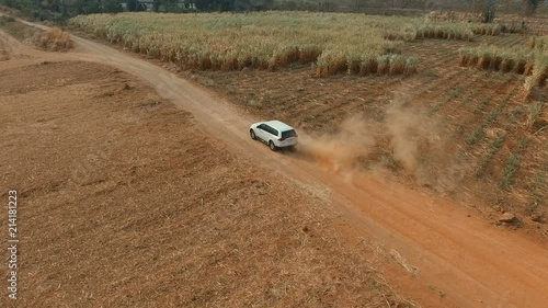 aerial veiw of suv car driving on dirt road photo