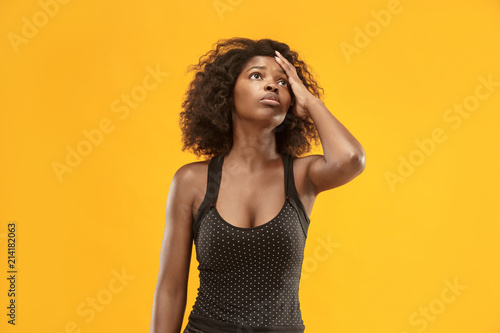 Woman having headache. Isolated over gold background.