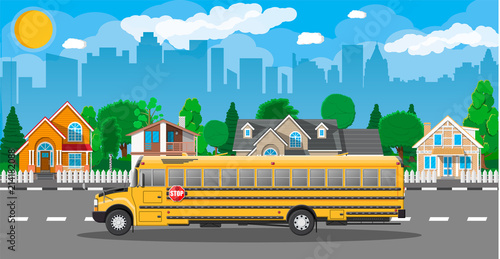 Yellow long classic school bus in city.