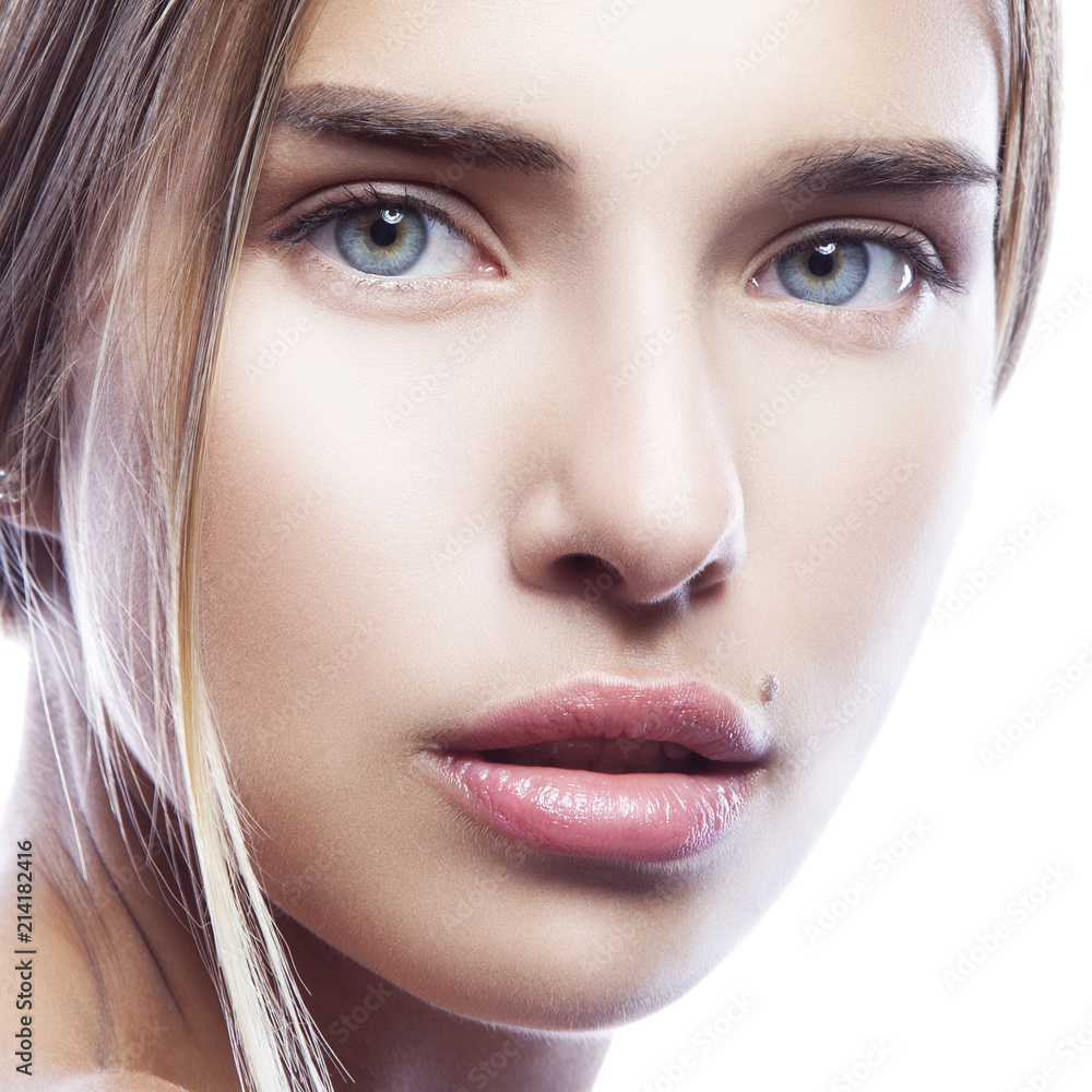 Close-up beauty face of young fashion model girl with natural lips, nude  make-up, perfect clean fresh skin and blue eyes. Skincare facial treatment  woman health concept. White background Stock Photo | Adobe