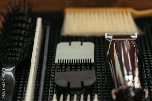 close-up view of comb, brushes and electric clipper in barbershop