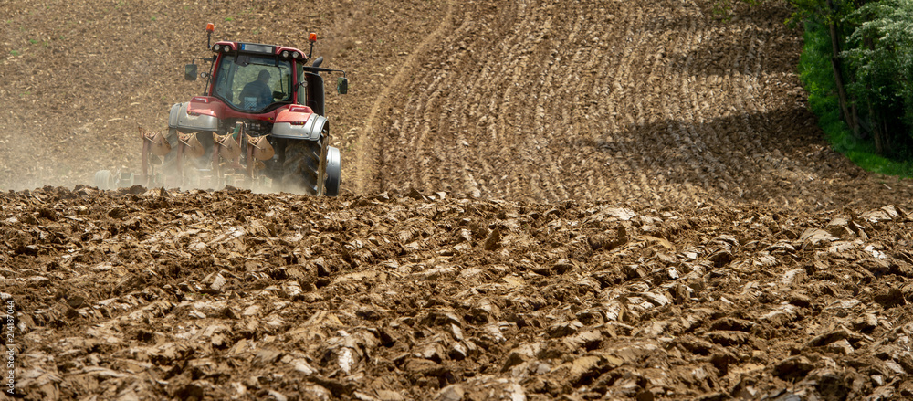 Farmer on tractor plow field, France Farmer on tractor plow field, France