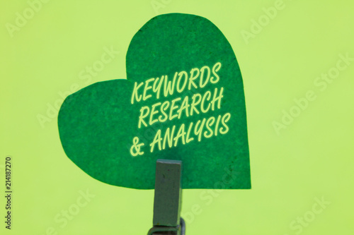 Conceptual hand writing showing Keywords Research and Analysis. Business photo showcasing search for data and create tables graphs Clothespin holding green paper heart romantic message ideas. photo