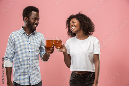Canvas Print The afro couple or happy young people laughing and drinking beer at studio
