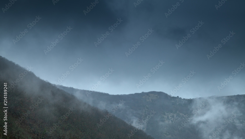 Dark mountains with fog and clouds