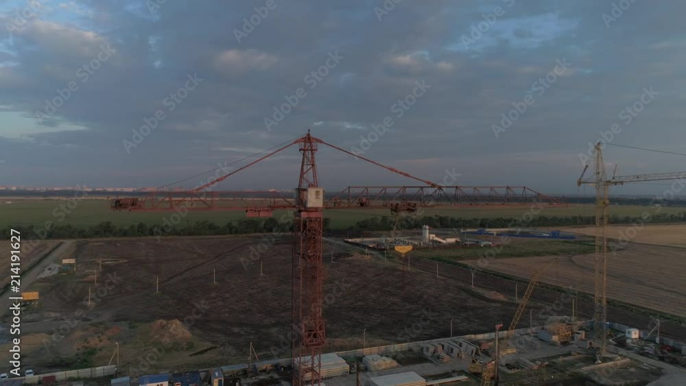 Aerial view - industrial construction crane in the field. Aerial view - industrial construction crane in the field.