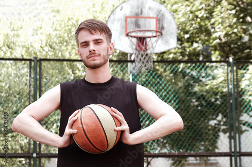 Basketball player practicing and posing for basketball. Background of the basketball ring © gesrey