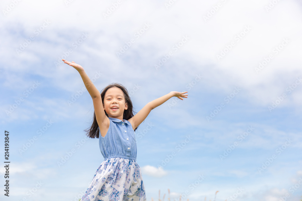 Happy beautiful child little girl white could and blue sky background with copy space Happy beautiful child little girl white could and blue sky background with copy space