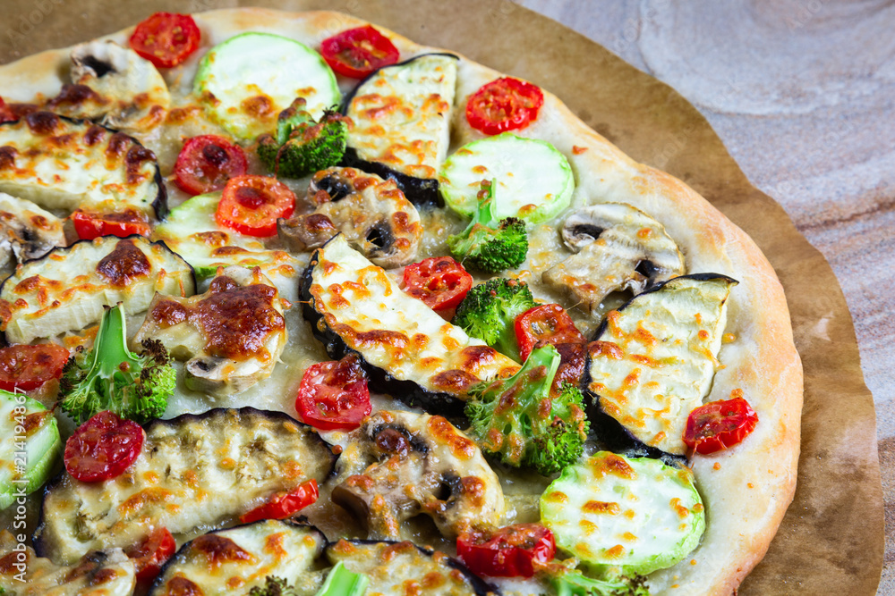 Homemade pizza with vegetables, natural dough on leaven. With zucchini, eggplant, cherry tomato, broccoli, mushrooms. The concept of a healthy diet. Vegetarian.