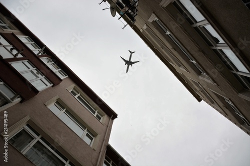 A plane is flying low over Balat houses