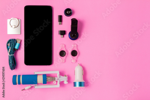 top view mobile device with mobile blank space for text,.accessories. micro USB Adapter, macro lens on pink background