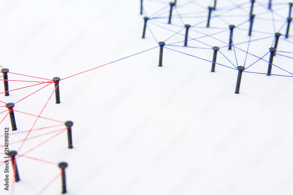 Connecting networks. two network connected with yarn red and blue on white paper. Simulator connection social media, internet, people communication Connecting networks. two network connected with yarn red and blue on white paper. Simulator connection social media, internet, people communication