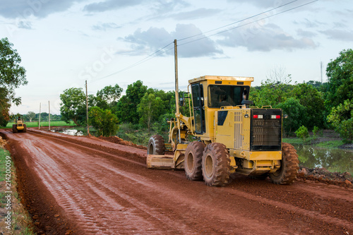 Schilderij op canvas Yellow motor grader Road working on road construction site of new road
