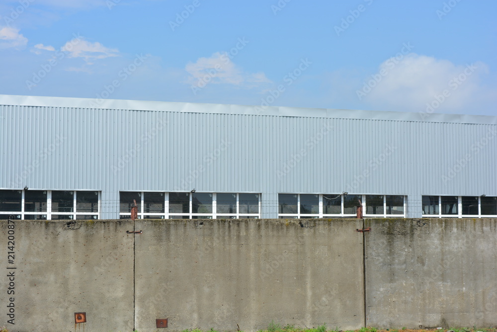 Warehouse building with concrete walls and white metal-plastic windows