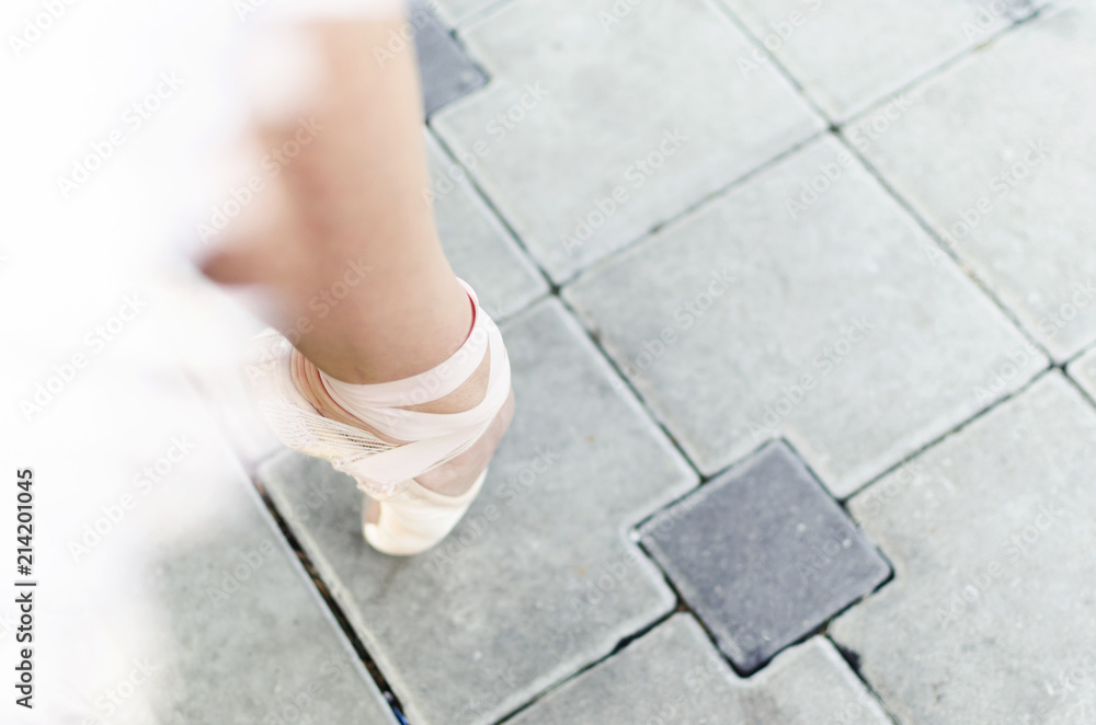 Foot of ballerina in ballet shoes