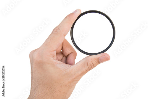 hand holding clear camera filter isolated on white with clipping path