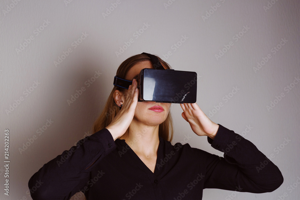 Beautiful blonde woman is wearing glasses of virtual reality Beautiful blonde woman is wearing glasses of virtual reality