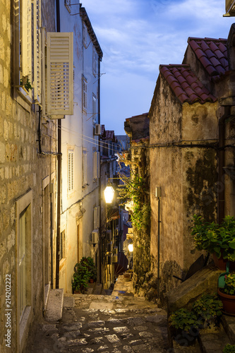 Fototapeta Naklejka Na Ścianę i Meble -  The atmospheric very narrow medieval street inside Dubrovnik old town at sunset in Croatia, Eastern Europe